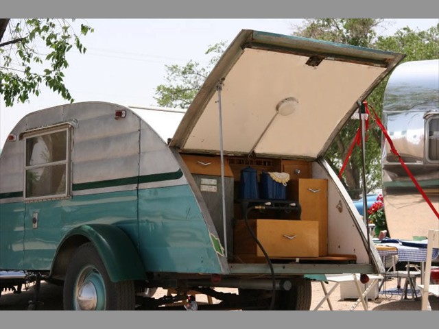 Her hatch lifts to reveal the outdoor camp kitchen  with old fashioned ice box